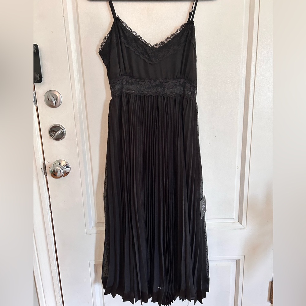 Really pretty black spaghetti strap dress with polka dot stitching overlay.